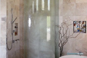 Bent Slump/cast glass shower enclosure - Slump/cast glass is much easier to maintain and keep clean then regular glass. This is one of the reasons why this glass is so popular for showers.