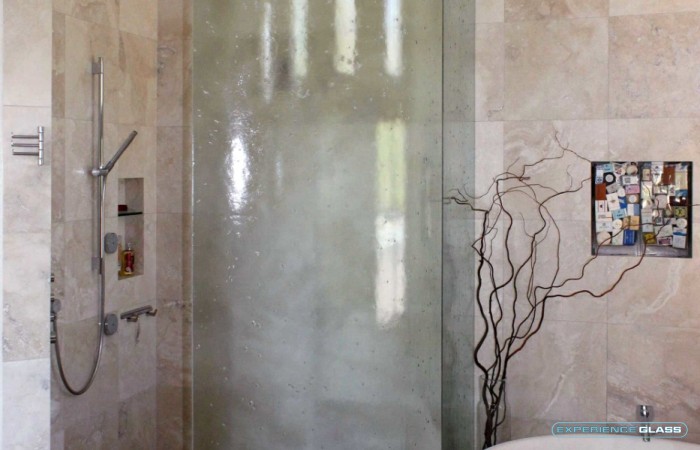 Bent Slump/cast glass shower enclosure - Slump/cast glass is much easier to maintain and keep clean then regular glass. This is one of the reasons why this glass is so popular for showers.